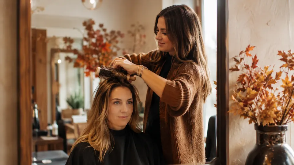 Cheveux clairsemés en automne, coiffeuse travaillant le volume racine d'une cliente